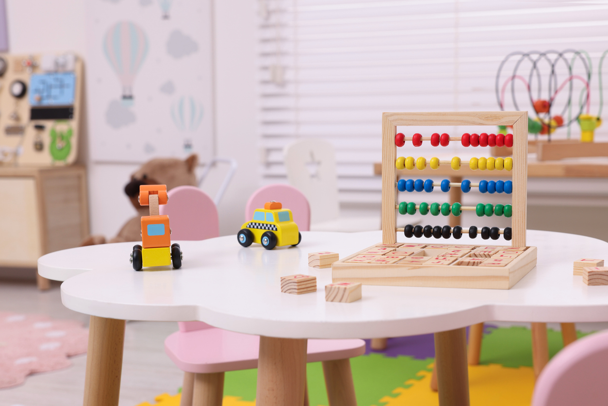 Different toys on table in playroom. Kindergarten interior